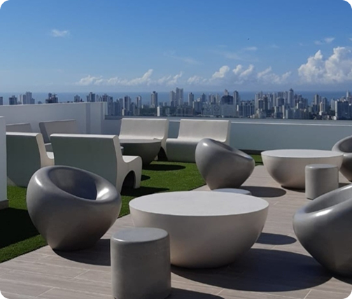 Outdoor concrete furniture set on rooftop terrace with city skyline